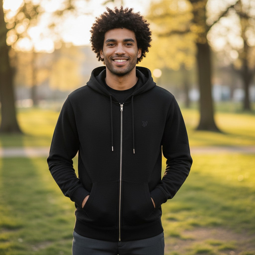 WILDVINE Clothing Co. men's black superfine knitted zip-through hoodie worn by a smiling man in a park.