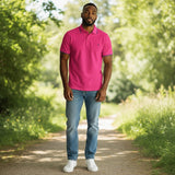 WILDVINE Clothing Co. grape pink 2-ply pique cotton polo shirt worn by a man on a nature path