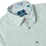 WILDVINE Clothing Co. light green textured short sleeve shirt with floral print collar lining and button-down front