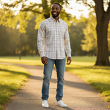 WILDVINE Clothing Co. man wearing a blue and black check long sleeve shirt with jeans in a sunny park setting