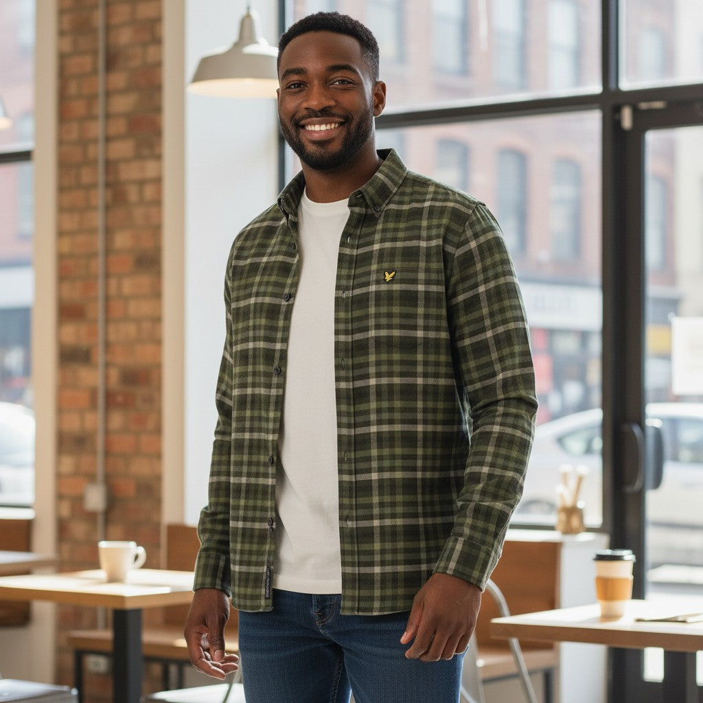 WILDVINE Clothing Co. man wearing a green tonal check button-down shirt with a golden eagle logo over a white tee.