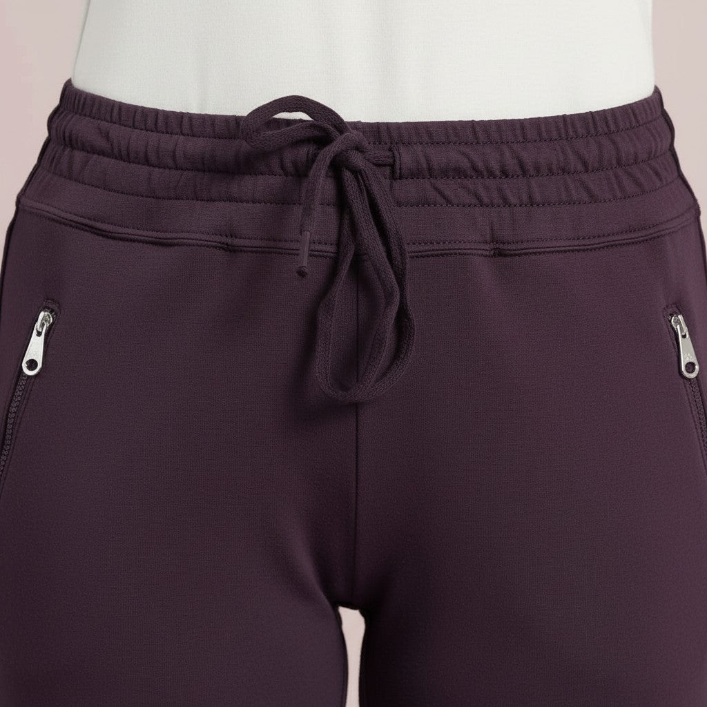WILDVINE Clothing Co. D.E.C.K By Decollage mulberry joggers featuring an elastic drawstring waist and zip pockets.