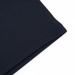 WILDVINE Clothing Co. dark navy polo shirt with light blue birdseye collar detail, close-up view of fabric texture.