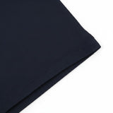WILDVINE Clothing Co. dark navy polo shirt with light blue birdseye collar detail, close-up view of fabric texture.