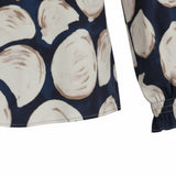 WILDVINE Clothing Co. navy blouse featuring a neutral circle print, long sleeves with gathered cuffs, and soft fabric.