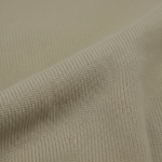 Close-up of sandstorm beige merino wool knit fabric from WILDVINE Clothing Co. showing fine texture and weave.