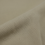 Close-up of sandstorm beige merino wool knit fabric from WILDVINE Clothing Co. showing fine texture and weave.
