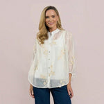 WILDVINE Clothing Co. white sheer blouse with floral embroidery, mandarin collar, and three-quarter sleeves on a model